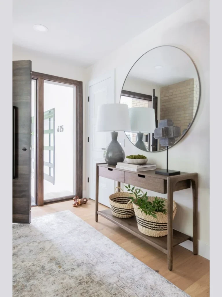A Round Mirror Above the Entryway Console