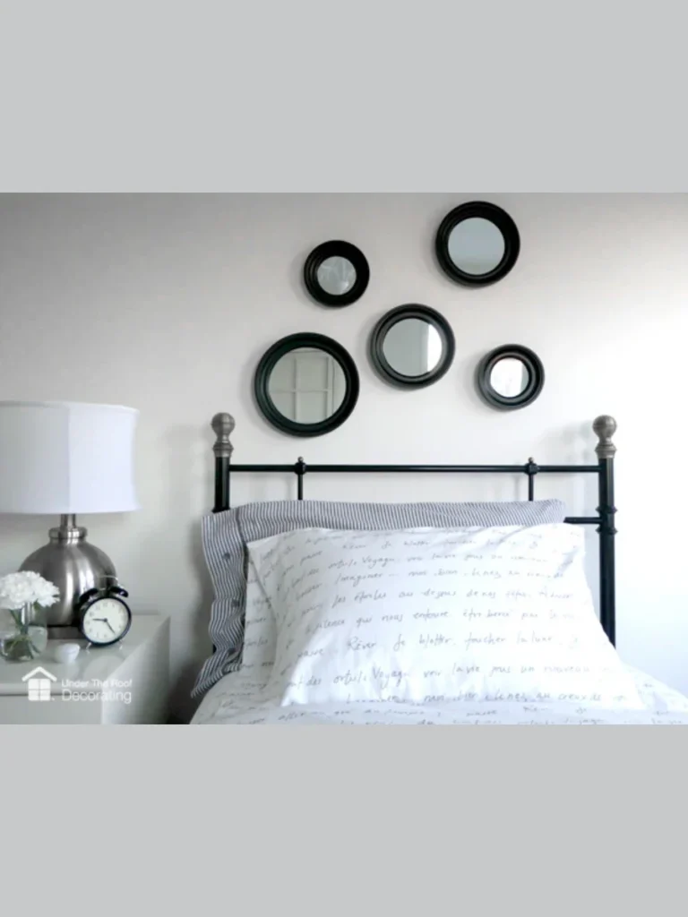 Small Mirrors Arranged Above a Headboard