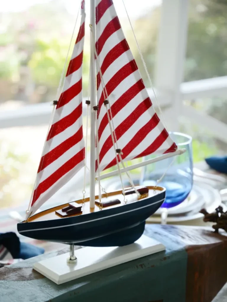 Arrange Miniature Red Painted Wooden Sailboats on a Navy Blue Gingham Runner for Holidays