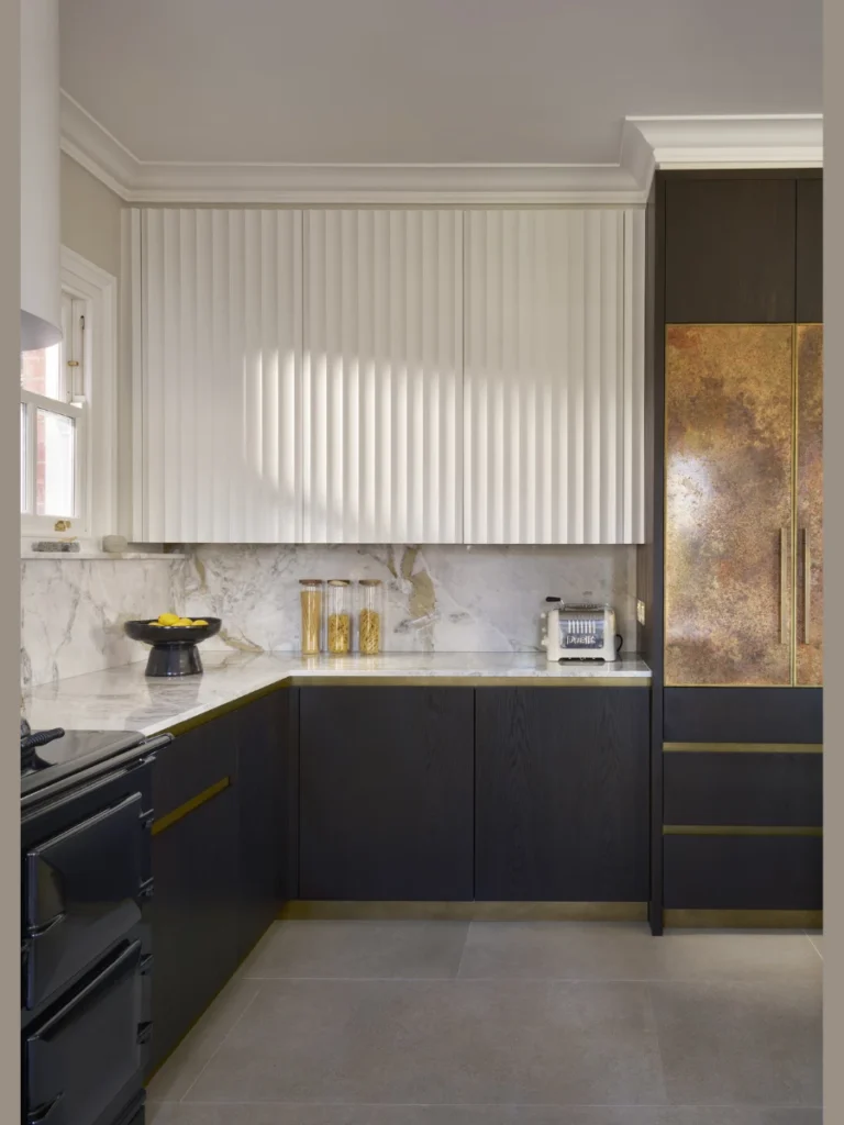 Fluted Shaker Cabinet Tops Accented by Glass Wall Sconces