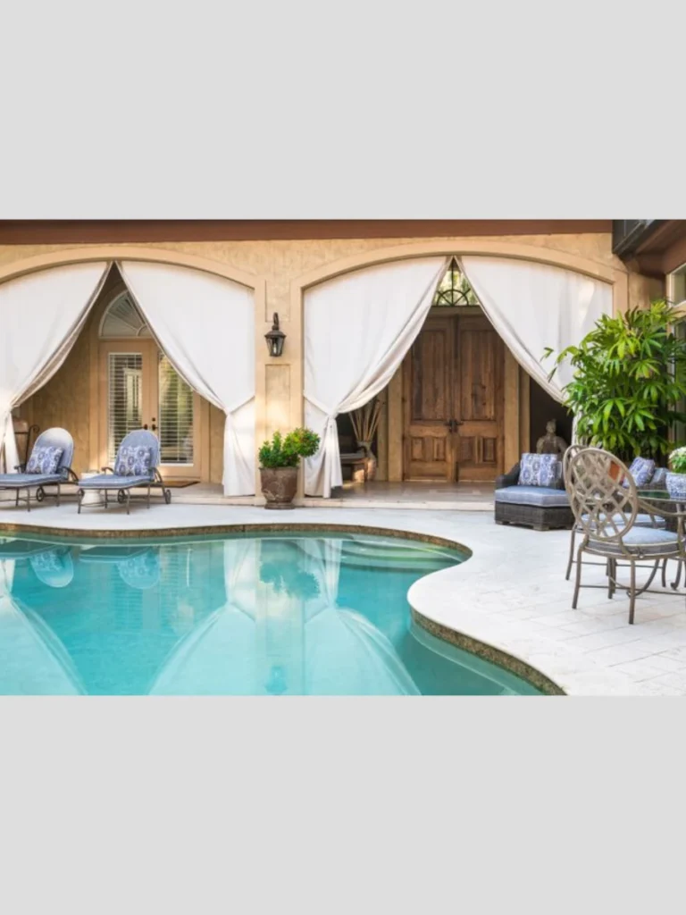Hang Sheer White Outdoor Curtains Around Covered Pergolas Poolside