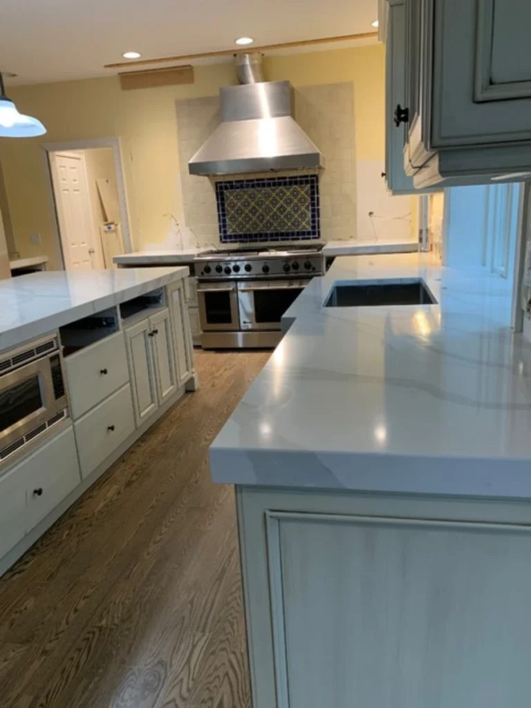 Heavily Veined Calacatta Quartz Countertops with Mitered Square Edges