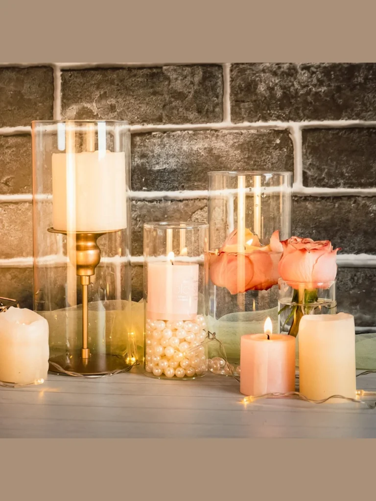 Layer Small Smooth Translucent Sea Glass Elements Around a Clear Glass Hurricane Vase