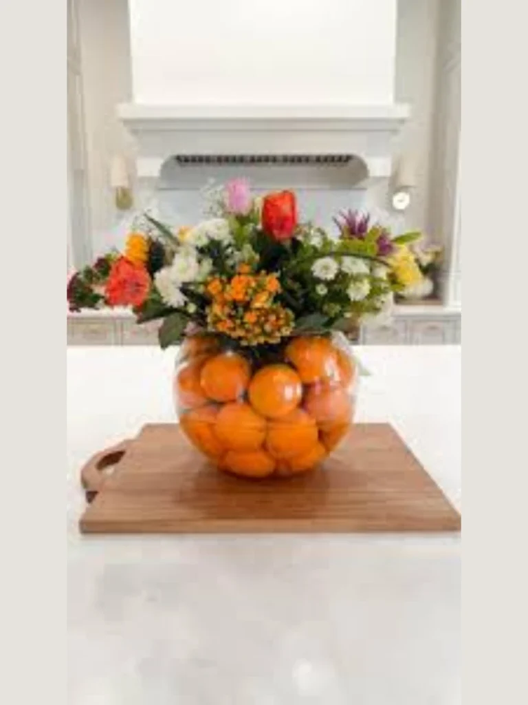 Position Two Small Terracotta Saucers Filled with Sliced Fresh Orange Halves for Color