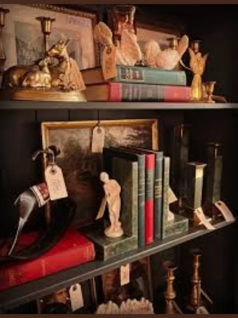 Position Unlacquered Brass Candlesticks Next to Sage Green Stacked Volumes