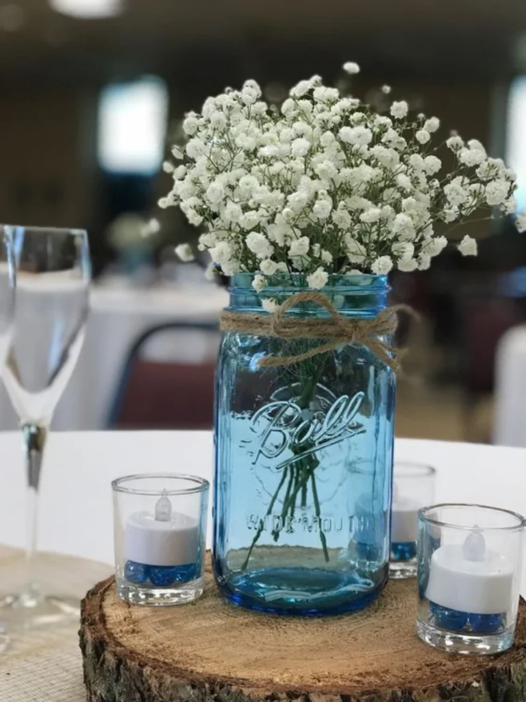 Slide Delicate White Baby's Breath Clouds Inside a Large Blue Mason Jar