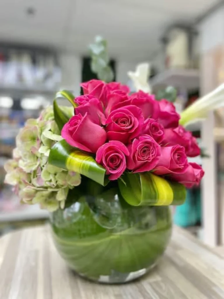 Slide Vivid Pink Garden Roses Inside a Clear Glass Bowl Filled with Fresh Lime Slices