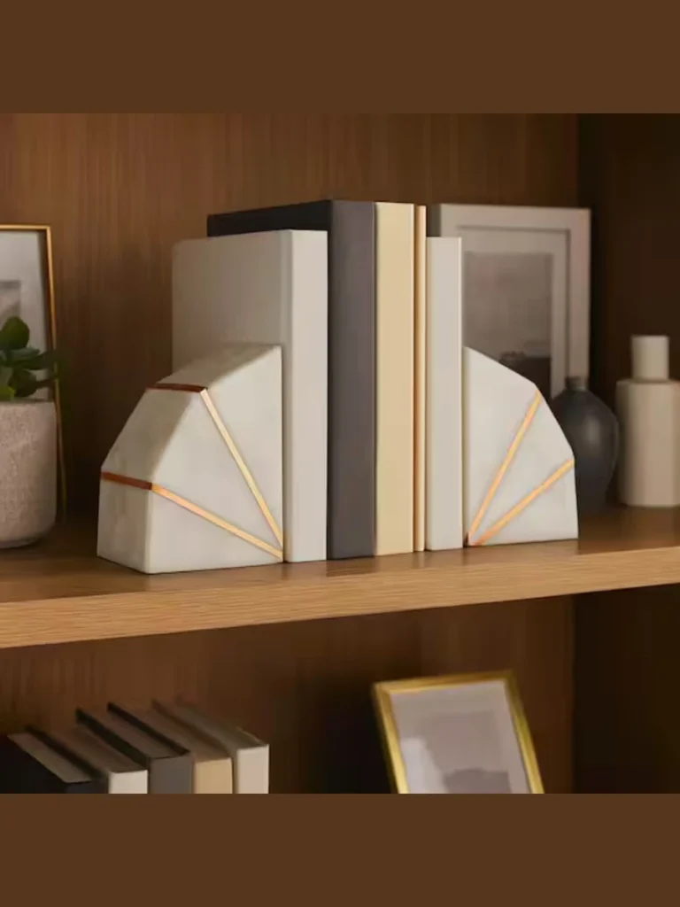 Stack Books Horizontally Topped with Polished White Marble Geometric Shapeson