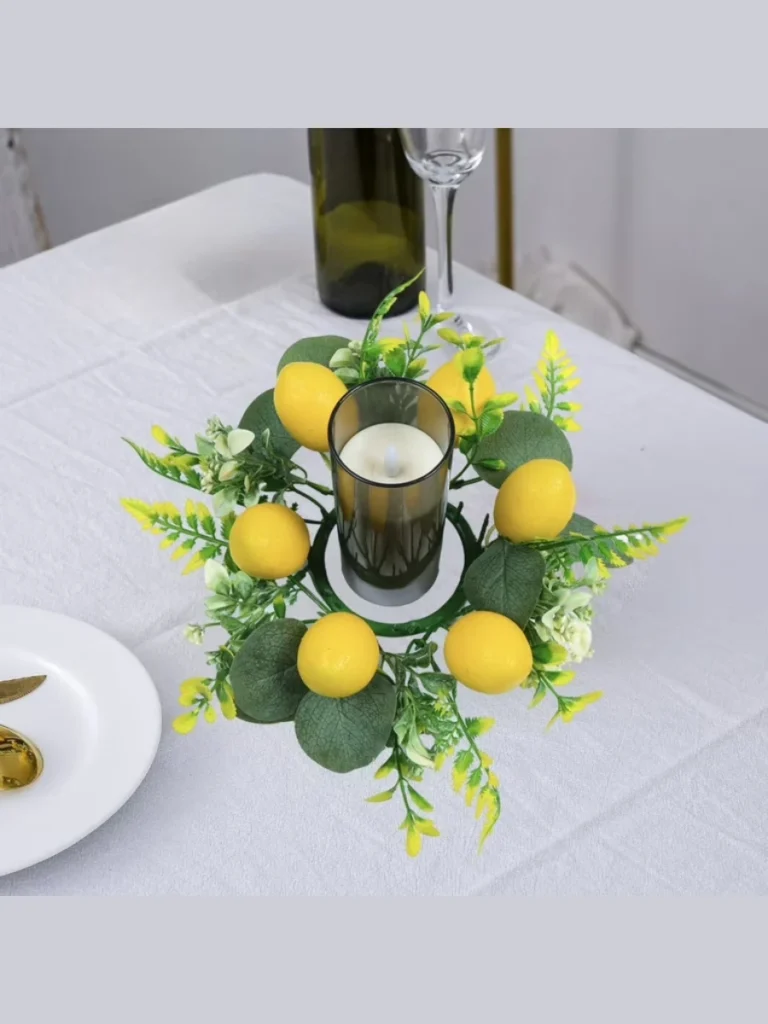 Twist a Strand of Fake Lemon Leaf Garland Around the Base of a Clear Glass Hurricane