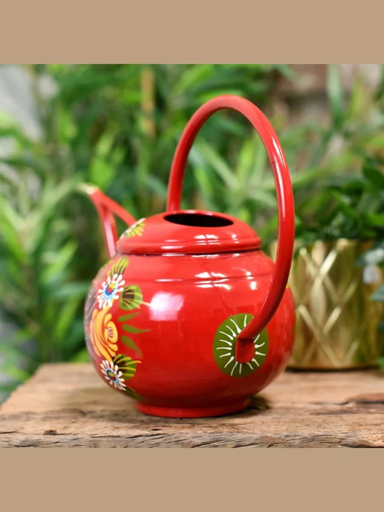Use a Bright Red Metal Watering Can as a Bookshelf Sculptural Object
