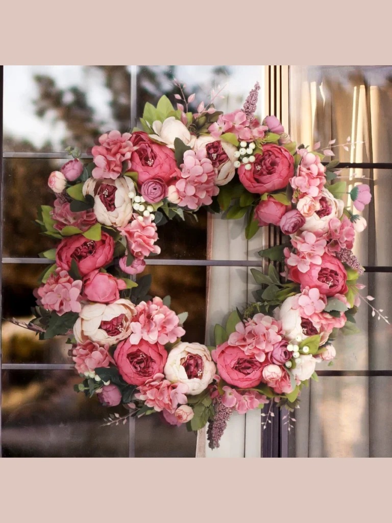 Weave Fluffy Coral Colored Artificial Peony Buds Across a Dark Vine Circle Frame